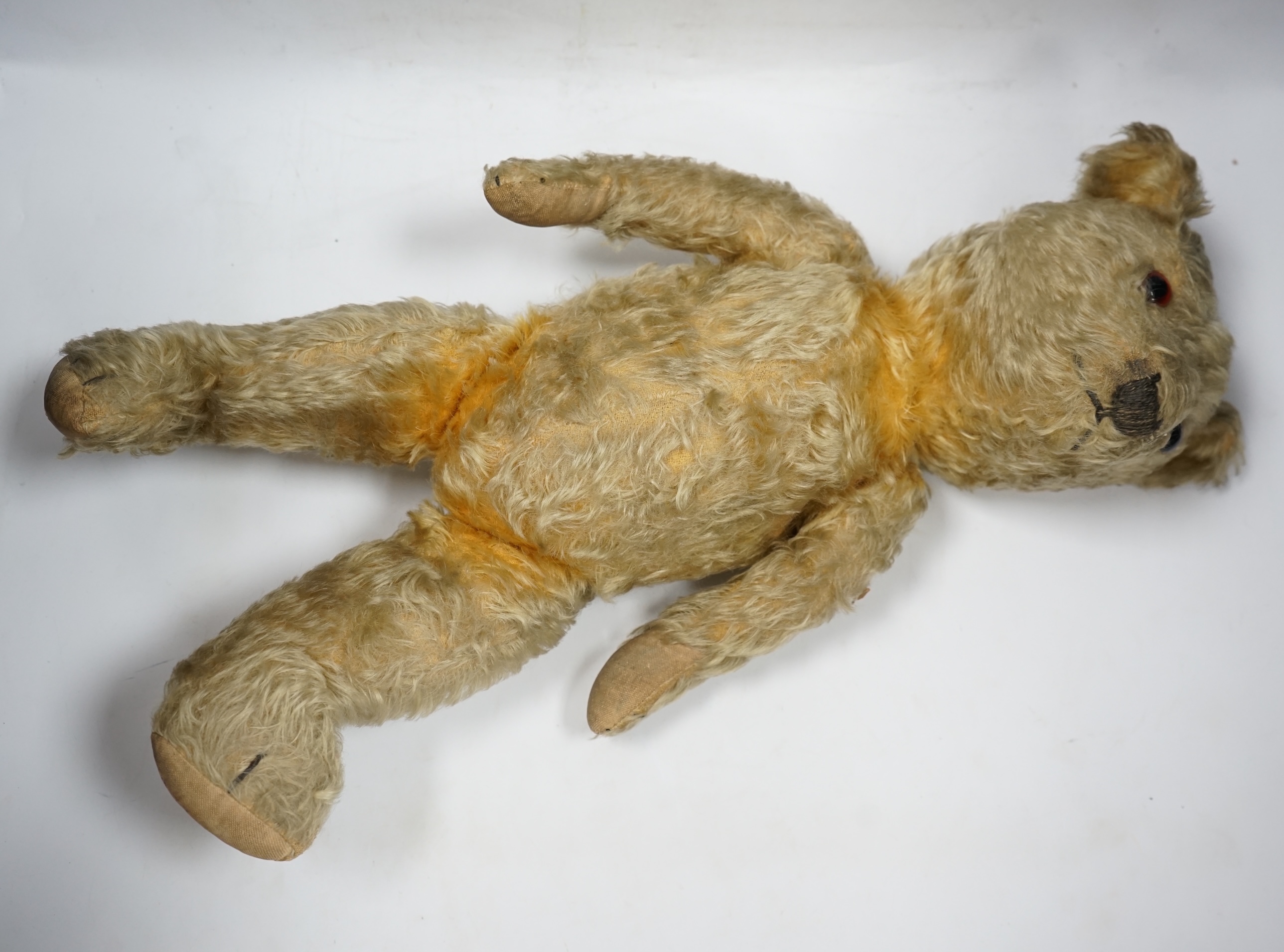 A 1930’s English Teddy bear, gold mohair plush and glass eyes, 49cm. Condition - fair